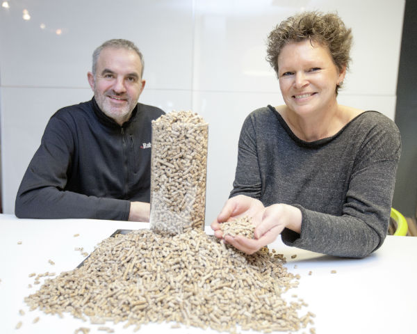 Michael and Kate Wright pictures with a pile of biomass pellets